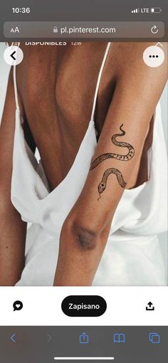 a woman with a snake tattoo on her arm