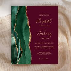 the burgundy and green wedding card has gold foil on it