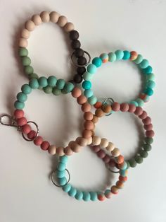 six bracelets with different colored beads on them