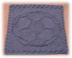 a blue knitted square with circles on it