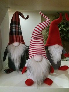 three gnomes with red and white hats on display