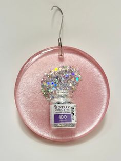 pearl pink  3d Botox vial with spilling silver glitter in cast resin. Super fun unique one of a kind gift for the Botox lover in your life.  Perfect gift for the dermatologist, plastic surgeon, nurse in your life! Or buy for yourself to enjoy for years to come.  We use only the highest quality products to make our items but some slight variations may be present from item to item making it even more unique.  We source the most durable hooks to add to the glam look as well as durability but are ha Beauty Ornaments, Obgyn Christmas Decor, Botox Christmas Tree, Medical Christmas Decorations, Botox Christmas, Medical Christmas Ornaments, Medical Christmas Tree Ornaments, Esthetician Inspiration, Pink Christmas Ornaments