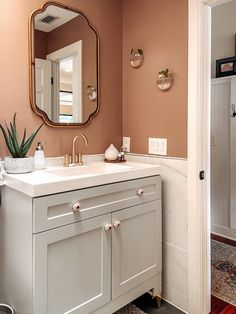 a bathroom with a sink and mirror in it