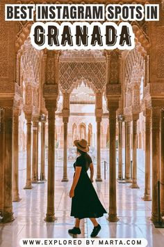 a woman in a black dress and hat walking through an ornate building with columns, arches and pillars