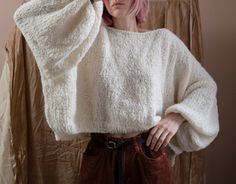 "Super soft and lightweight sweater with balloon sleeves from alpaca/wool blend. Materials: 80% Alpaca, 15% Wool, 5% Polyamide Color of the modeled sweater: off white; ocean Measurements: Length: front 17,7\" = 45 cm back 19,6\" = 48 cm Chest: 32\" = 81 cm Measures of Model in the photo Size: S Chest: 32\" - 82 cm Weist: 24\" - 62 сm Hip: 34\" - 88 cm Height: 66\" - 170 cm CARE INSTRUCTIONS: DRY CLEAN is the best way. HAND WASH. Make sure to use cold water and neutral soap. The less you touch an Cozy Oversized Tops With Balloon Sleeves, Oversized Soft Knit Sweater With Balloon Sleeves, Oversized Balloon Sleeve Sweater In Soft Knit, Oversized Knit Sweater With Balloon Sleeves, Cozy Balloon Sleeve Sweater, Cozy Sweater With Balloon Sleeves And Soft Knit, Oversized Alpaca Soft Knit Sweater, Oversized Soft Knit Alpaca Sweater, Oversized Hand-knitted Alpaca Sweater