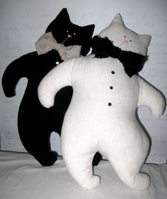 two black and white stuffed animals on a bed