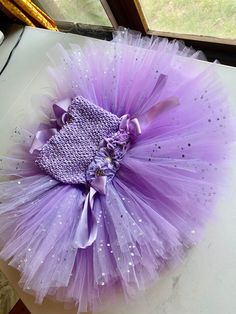 Welcome to Baby/Infants Clothing  by Funkids&Us Boutique Your Little Darling would look adorable with this beautiful Lavender  glitter tulle Birthday Smash  cake tutu dress.  Simplicity is gorgeous This dress is made with double-layered Tulle tone soft Lavender and glitter lavender tulle double layered strand of tulle each knot in purple crochet tutu top. The dress is in knee length size. the top bodice design with fabric flower with rhinestone.  MADE TO ORDER DRESS - Available in many colors . Lavender Tulle Tutu Dress For Party, Purple Tulle Birthday Dress, Whimsical Purple Tutu Dress With Ruffles, Sweet Tulle Tutu Dress For Birthday, Princess Style Glitter Tulle Tutu Dress For Birthdays, Cute Lavender Party Dress, Purple Whimsical Tutu Dress For Party, Whimsical Purple Tutu Dress For Party, Cute Purple Tulle Tutu Dress