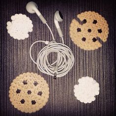 an assortment of crocheted cookies and earbuds laid out on the floor