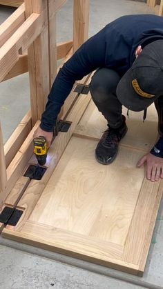 a man is working on some wood