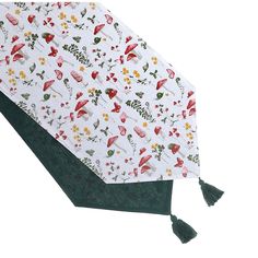 an umbrella with floral designs and tassels on the handle is laying flat against a white background