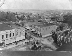 an old black and white photo of buildings