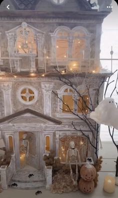 a doll house with halloween decorations and lights