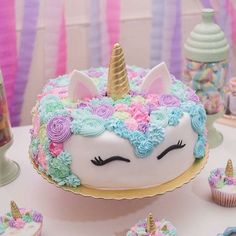 there is a cake with unicorn decorations on it