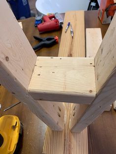 a wooden bench being built with tools on the table