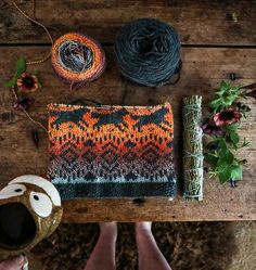 someone is holding their handmade bag on the table next to some yarn and scissors