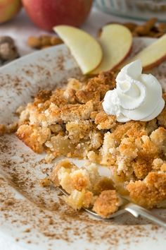 an apple crisp pie with whipped cream on top