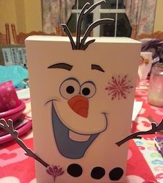 a paper bag with an image of a frozen princess character on it sitting on top of a table