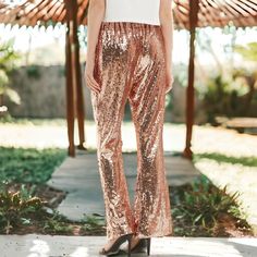 Get ready to dazzle in our Sparkly Sequin Flare Wide Leg Pants! These disco-inspired pants feature an elastic, stretchy waistband for comfortable wear day or night. With their relaxed, wide leg fit and shimmering sequins, they're perfect for anyone looking to make a statement on the dance floor! Spring Sequined Stretch Bottoms, Spring Sequin Stretch Bottoms, Spring Stretch Sequin Bottoms, Spring Party Stretch Leggings, Pink Stretch Bottoms For Night Out, Pink Leggings For Night Out In Spring, Trendy Stretch Sequined Bottoms, Stretch Pink Bottoms For Night Out, Trendy Stretch Bottoms With Sequins