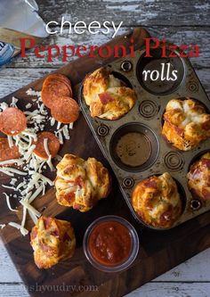 mini pepperoni pizzas in a muffin tin on a cutting board with cheese and ketchup