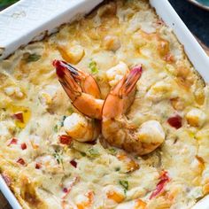 a casserole dish filled with shrimp and cheese