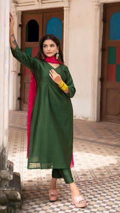 Bring on the festive spirit with our kurta set in chanderi silk. Fully lined kurta and pants. Made in chanderi silk. Dupatta in mul cotton with intricate tikki details. Color of Kurta + Pants : Dark Green. Color of Dupatta : Rani Pink. Model height is 5.3” and is wearing a size S. Wash Care : Dry Clean Only Festive Tussar Silk Palazzo Set For Eid, Eid Festive Tussar Silk Palazzo Set, Festive Eid Tussar Silk Palazzo Set, Festive Unstitched Tussar Silk Palazzo Set, Festive Tussar Silk Palazzo Set With Straight Kurta, Raw Silk Straight Kurta With Dabka, Festive Tussar Silk Palazzo Set, Transitional Chanderi Kurta With Zari Work, Designer Cotton Silk Palazzo Set With Straight Kurta