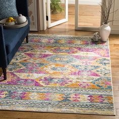 a brightly colored area rug in a living room