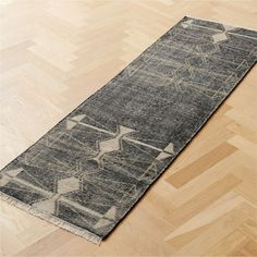 a long rug on the floor in an empty room with wood floors and parquets