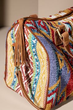 From its gorgeously woven ethnic motif to its genuine suede handle and tassel detail, this boston bag is sure to be the envy of everyone in the room! It'll show off your style with its unique charm, and let's face it, it's pretty darn cute. Get ready to make a statement! - Shell: 100% Cotton- Lining: 100% Polyester- APPROX. L 9" W 12.5" Mini Duffel Bag, Purple Bags, Boston Bag, Adventure Awaits, Sedona, Unique Charms, Duffel Bag, Tulum, Compact Design