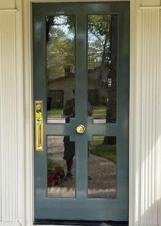 a man standing in front of a door with a dog on the ground next to it