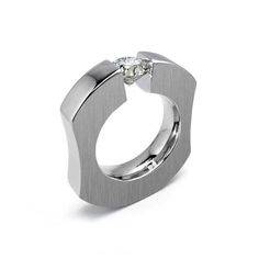 Bold ergonomic design ring with a tension set radiant high quality round White Sapphire. Ideal for men, but women love it too. ‣ View Collection ABBRACCI https://etsy.me/2NrpPLQ Metal: 316 stainless steel, hypoallergenic and tarnish free. Metal finish: polished and brushed Mounting measurement: Top and bottom 5mm, sides 3mm. Comfort fit Gemstone size: 1ct * This ring is specifically crafted for you, will ship in 1 to 2 weeks - Free USA shipping * NOTE: Prior placing the order, We strongly recommend having your ring finger sized by a professional jeweler. All errors on selecting a size may incur in resizing fees. Modern Rings With Tension Setting As Gift, Elegant Titanium Rings For Anniversary, Modern White Gold Rings With Tension Setting, Modern Brilliant Cut Rings, Contemporary Diamond Ring With Tension Setting For Anniversary, Modern Brilliant Cut Diamond Ring, Adjustable Silver Ring With Tension Setting, Luxury Tension Setting Men's Ring, Luxury White Tension Setting Ring