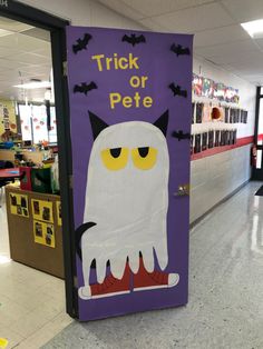 a purple door with a white cat on it that says trick or pete in yellow eyes