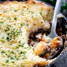 a close up of a casserole with meat and vegetables