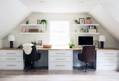 an attic office with two desks and shelves