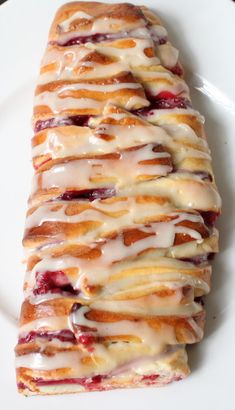 a white plate topped with pastry covered in icing