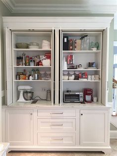 two white cabinets with open doors in a kitchen