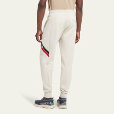 Moncler fleece-lined sweatpants with side striping and a logo patch Regular rise Drawstring waistband  Side welt pockets Single back welt pocket Full length  Banded cuffs Pull-on style  Cotton Machine wash cold Imported Sportswear Joggers With Logo Detail For Jogging, Athleisure Joggers With Logo Detail For Jogging, Sports Joggers With Logo Detail And Relaxed Fit, Relaxed Fit Sports Joggers With Logo Detail, White Joggers With Ribbed Cuffs, Sporty Jogging Bottoms With Logo Detail, Sporty Logo Detail Bottoms For Jogging, Sporty Bottoms With Logo Detail For Jogging, Sportswear Pants With Logo Detail For Sports