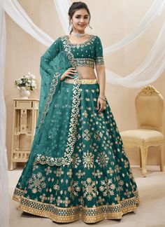 Elevate your style with our Teal Designer Silk Lehenga. Designed for the sophisticated and exclusive woman, this lehenga boasts intricate embroidery and a flowing silhouette. Perfect for weddings, parties, or any special occasion, our lehenga exudes luxury and elegance. Make a statement with our designer lehenga today. The unstitched blouse can be customized upto 46 inches. Do Note: All the accessories shown are for styling purpose only. Slight color variation may occur due to photographic reaso Green Lehenga Choli, Lehenga Choli Designs, Bridesmaid Lehenga, Party Wear Lehenga Choli, Green Lehenga, Blue Lehenga, Lehenga Online, Choli Designs, Net Lehenga