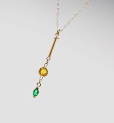 This is a truly unique and wonderful Minimalist 14k gold necklace with a 14k solid yellow gold dainty 1mm cable chain and a high quality Colombian natural emerald pendant with a natural citrine gem of great quality. The high quality natural vibrant green emerald marquise gem measures 5x3mm and is set in a solid gold bezel. The beautiful deep yellow brilliant cut round 5mm citrine is also set in a 14k solid gold light bezel and accompanies the 12mm long 14k solid gold tube that makes this necklac Minimalist Emerald Necklace In Yellow Gold, Minimalist Gold Emerald Gemstone Necklace, Gold Emerald Birthstone Necklace In Minimalist Style, Gold Minimalist Emerald Birthstone Necklace, Minimalist Gold Emerald Birthstone Necklace, Minimalist Gold Emerald Necklace In Sterling Silver, Dainty 14k Gold Emerald Necklace, Dainty Yellow Gold Emerald Jewelry, Minimalist Gold Emerald Necklace With Delicate Chain