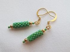 Opaque rainbow lime green Delicas are woven into tube beads and framed with gold plated round beads in these fun earrings. Great to wear for both formal and casual occasions. They hang from gold plated ear wires and measure 1.25 inches long. Beaded Charms, Beadwork Bracelet, Beaded Beads, Glass Beaded Bracelets, Rochester Ny, Bead Jewelry, Tube Beads, Fun Earrings, Glass Earrings