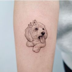 a small dog with a flower in it's hair is shown on the arm