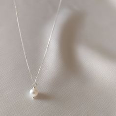 "Timeless, Simple & Delicate Bridesmaid Pearl Necklace in Sterling Silver 925. Looking for: - a Stunning Pearl Necklace for every day wear - a Gift for your Bridesmaids or - a Feminine Elegant Necklace for Her as a gift Whatever the reason may be, this pearl necklace is perfect for every occasion. This pearl necklace is the PERFECT GIFT for every Woman. So delicate and feminine. We use only HIGH QUALITY materials and offer guarantee on our necklaces. We are a 5-Star Seller. Check our reviews Minimalist White Charm Necklace For Anniversary, Classic Wedding Pendant Charm Necklace, Simple Silver Charm Necklaces For Wedding, Classic Silver Charm Necklace For Wedding, Classic Sterling Silver Charm Necklace For Wedding, Classic Pearl Drop Charm Necklace As Gift, Classic Pearl Drop Charm Necklaces As Gift, White Necklace With Sterling Silver Clasp For Everyday, White Sterling Silver Clasp Necklace For Everyday