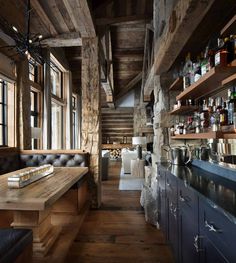 the interior of a rustic log cabin with wood flooring and exposed beams, built into the ceiling