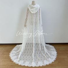 a white lace wedding gown is on display