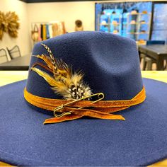 Beautiful Hat I Decorated. Very Unique. Blue Fedora With Flat Brim, One Size Fits Most, Blue Wide Brim Felt Hat For Fall, Blue Fedora Hat One Size Fits Most, Blue Flat Brim Fedora One Size Fits Most, Blue Fedora With Flat Brim, Blue Flat Brim Fedora One Size, Blue Adjustable Felt Hat With Short Brim, Fall Wide Brim Blue Felt Hat, Fall Blue Wide Brim Felt Hat