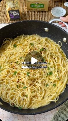 a pan filled with pasta and sauce on top of a table next to other ingredients