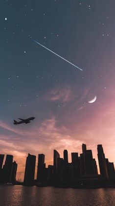 an airplane is flying over the city at night