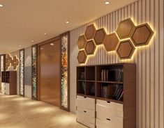 an empty room with many shelves and lights on the wall, along with several bookshelves