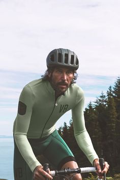 a man riding a bike on top of a lush green field