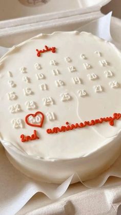 a white cake with red icing and numbers on it