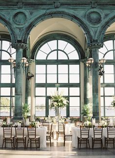 the tables are set in front of large windows